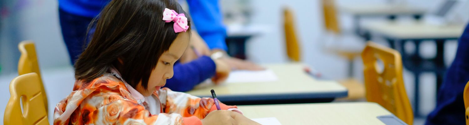 child sitting in school, private school