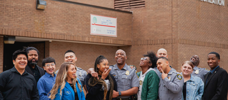 Wayland Cubit surrounded by a group of young adults he helped at St. Joseph's Children's Home