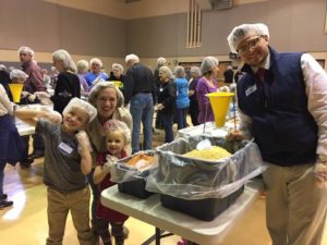 Aly Shahan and her family working at a food service project