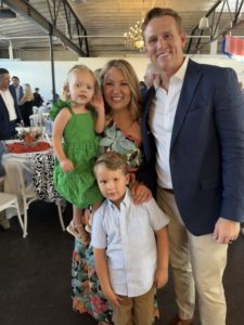The author with her husband, preschool-aged son and toddler daughter posing together and smiling at the camera.