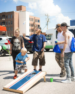 Families play games outside at an event where Diversion Hub supports families with events and services