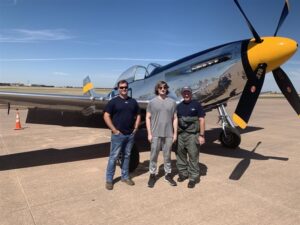 A student and flight professor posing in front of plane. The aviation academy shows how charter and public schools can work together.