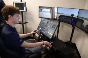 A student in a flight simulator. The aviation academy shows how charter and public schools can work together.