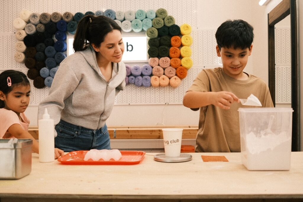 Families create colorful coasters in parent-child art classes at Rug Club. 